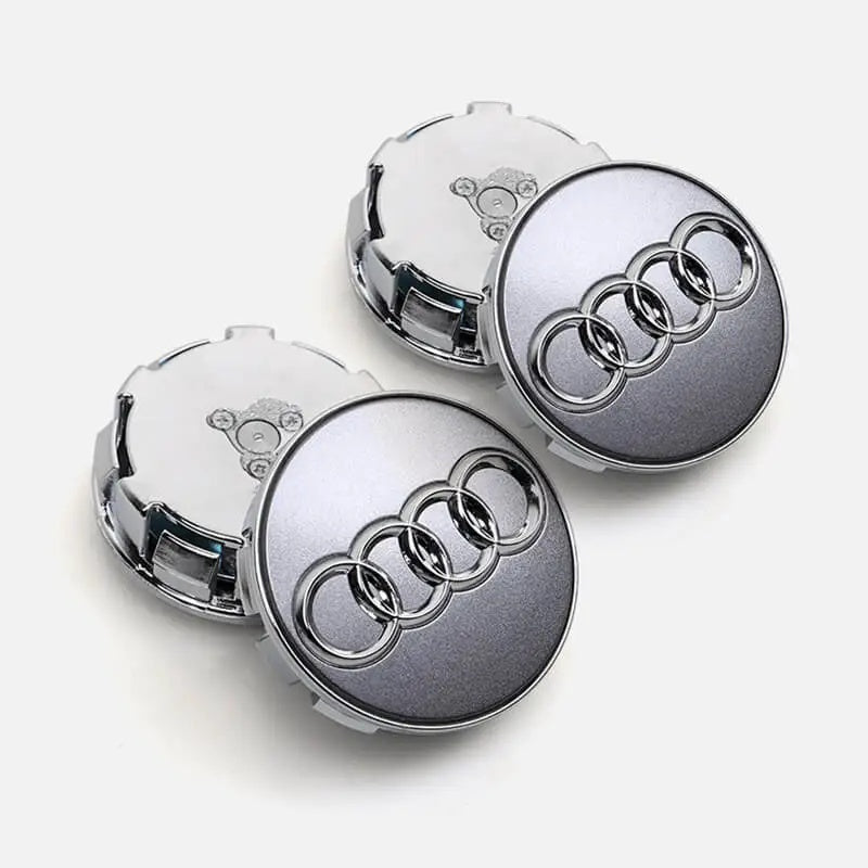 Silver grey Audi floating centre caps set on grey background