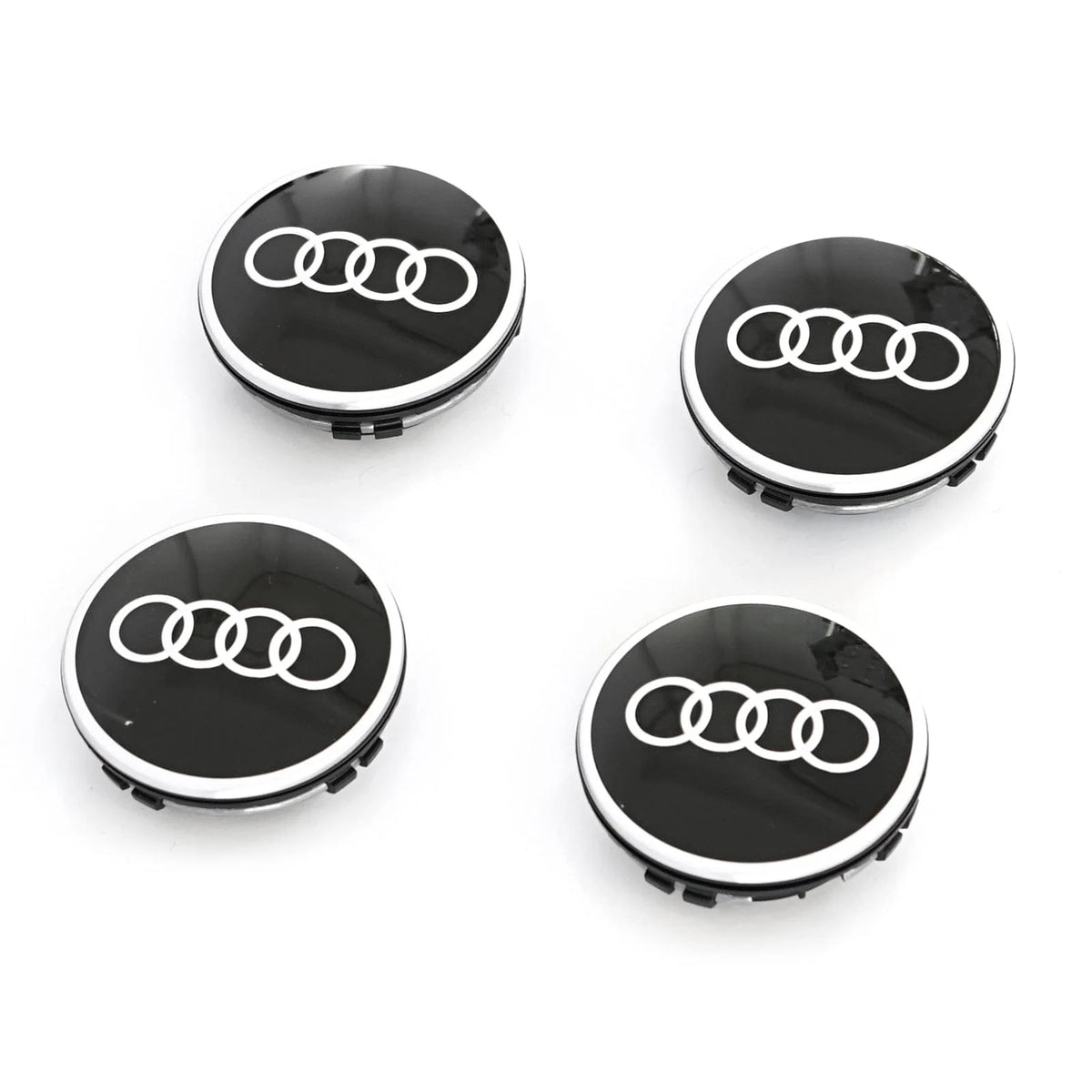 Four black floating centre caps with silver Audi rings logo