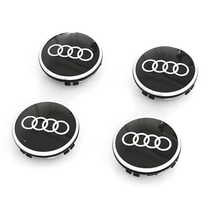 Four black floating centre caps with silver Audi rings logo