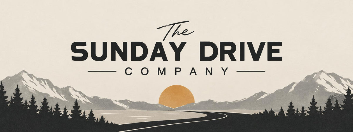 The Sunday Drive Company banner, mountain road at sunset