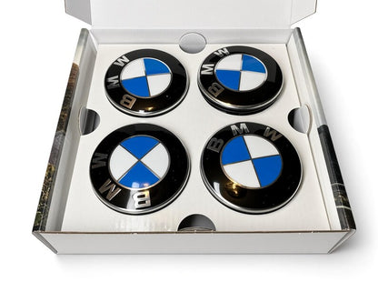 Four BMW floating centre caps with blue and white roundel in open white box