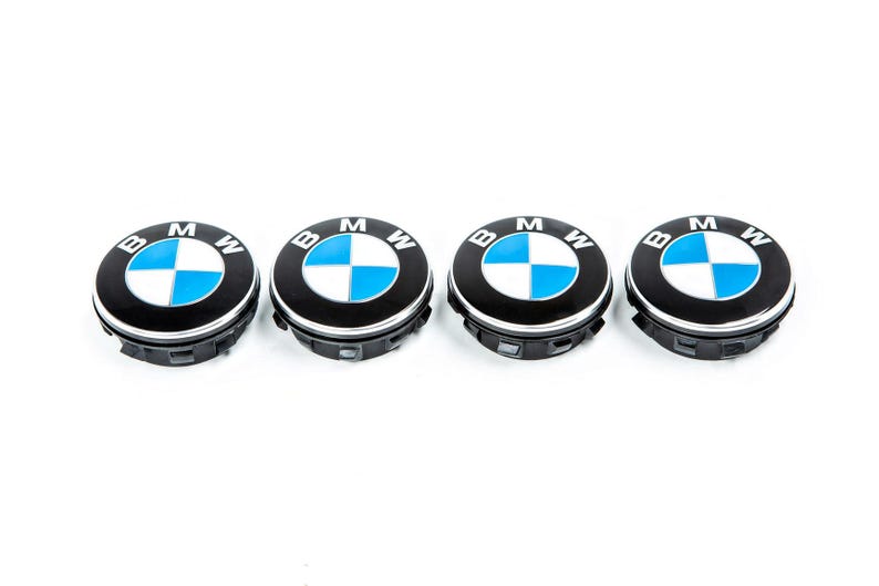 Set of four BMW blue and white floating centre caps in a row