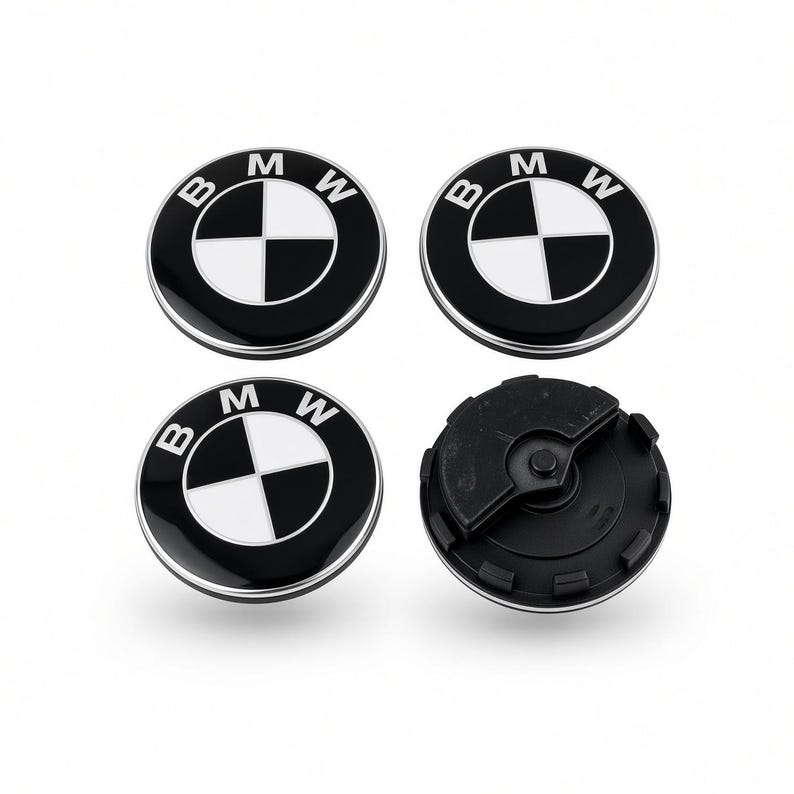 Black and white BMW floating centre caps, one shown from the back