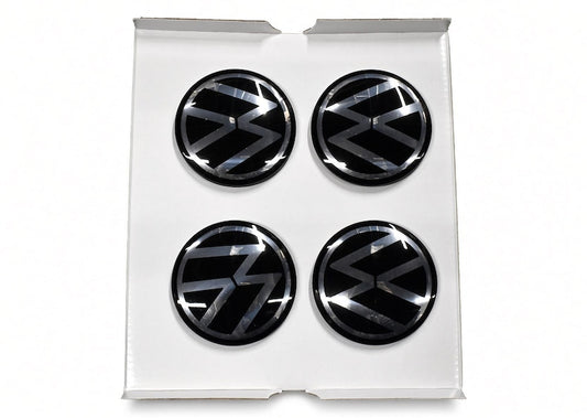 Four black floating centre caps with VW logo in white gift box