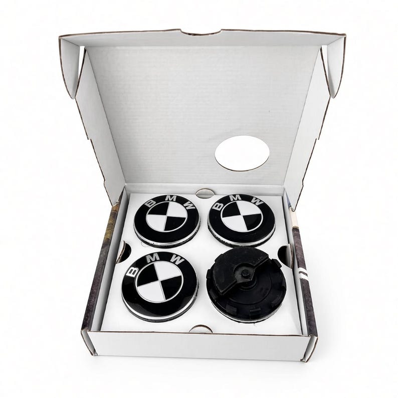 Black and white BMW floating centre caps in open white box